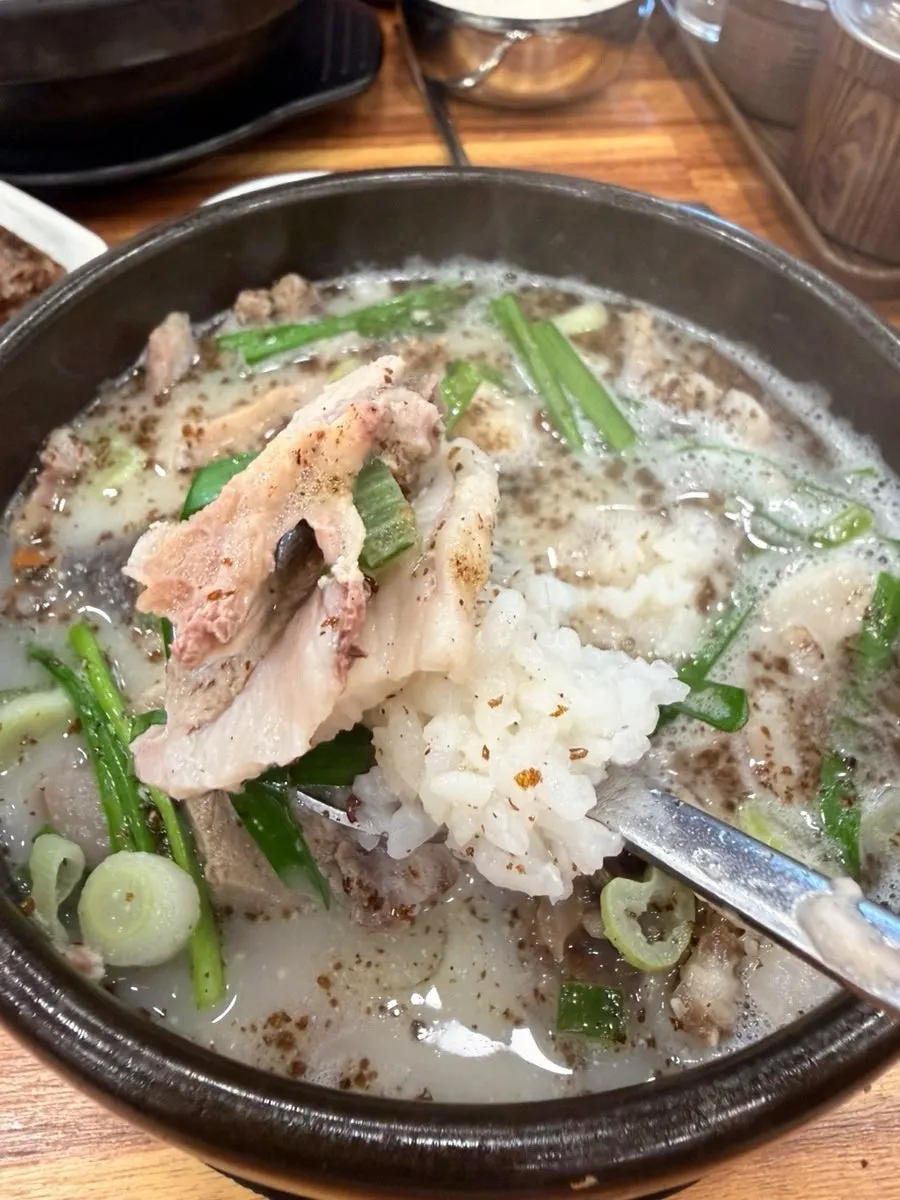 A spoonful of sundae-guk mixed with rice and packed with filling