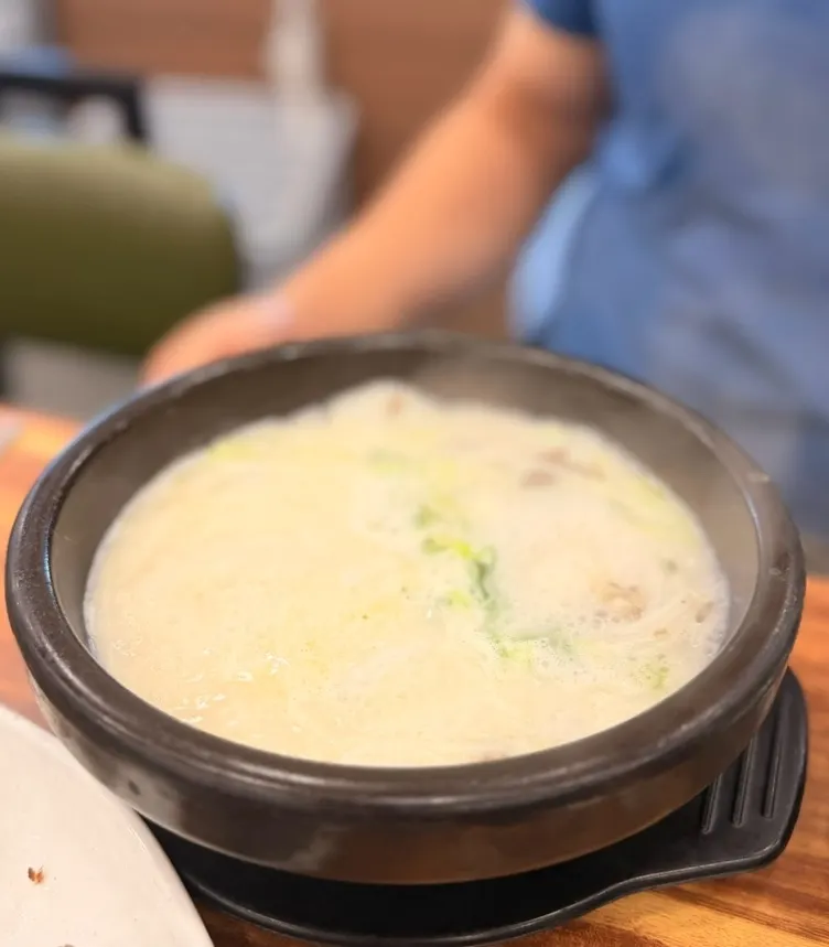 Seolleongtang earthenware bowl with milky broth and wheat noodles