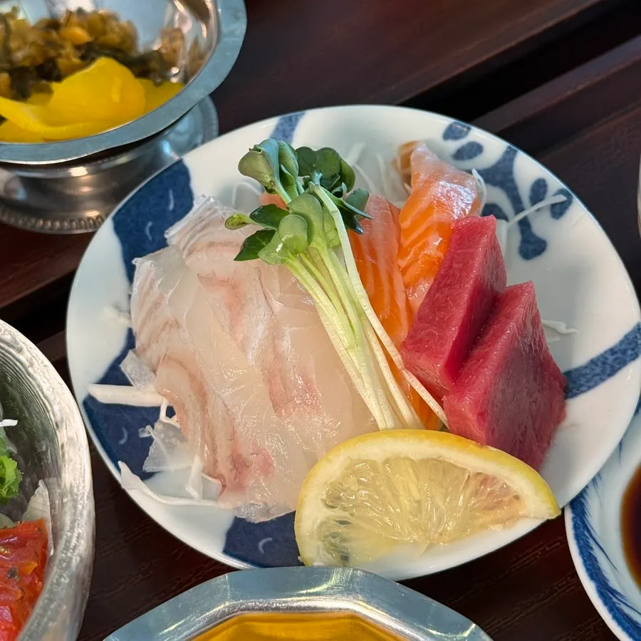 Sushi being dipped in soy sauce
