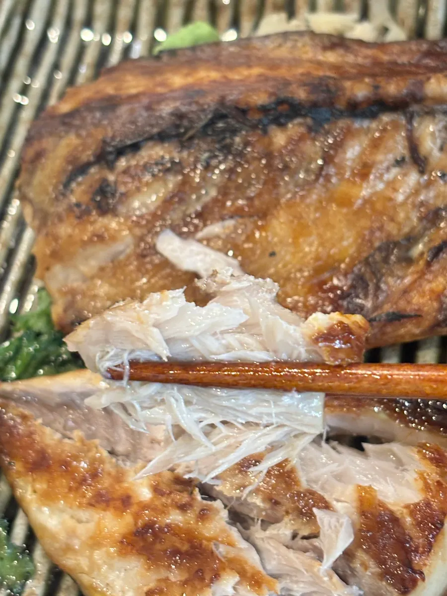 Salted grilled mackerel shared with a child