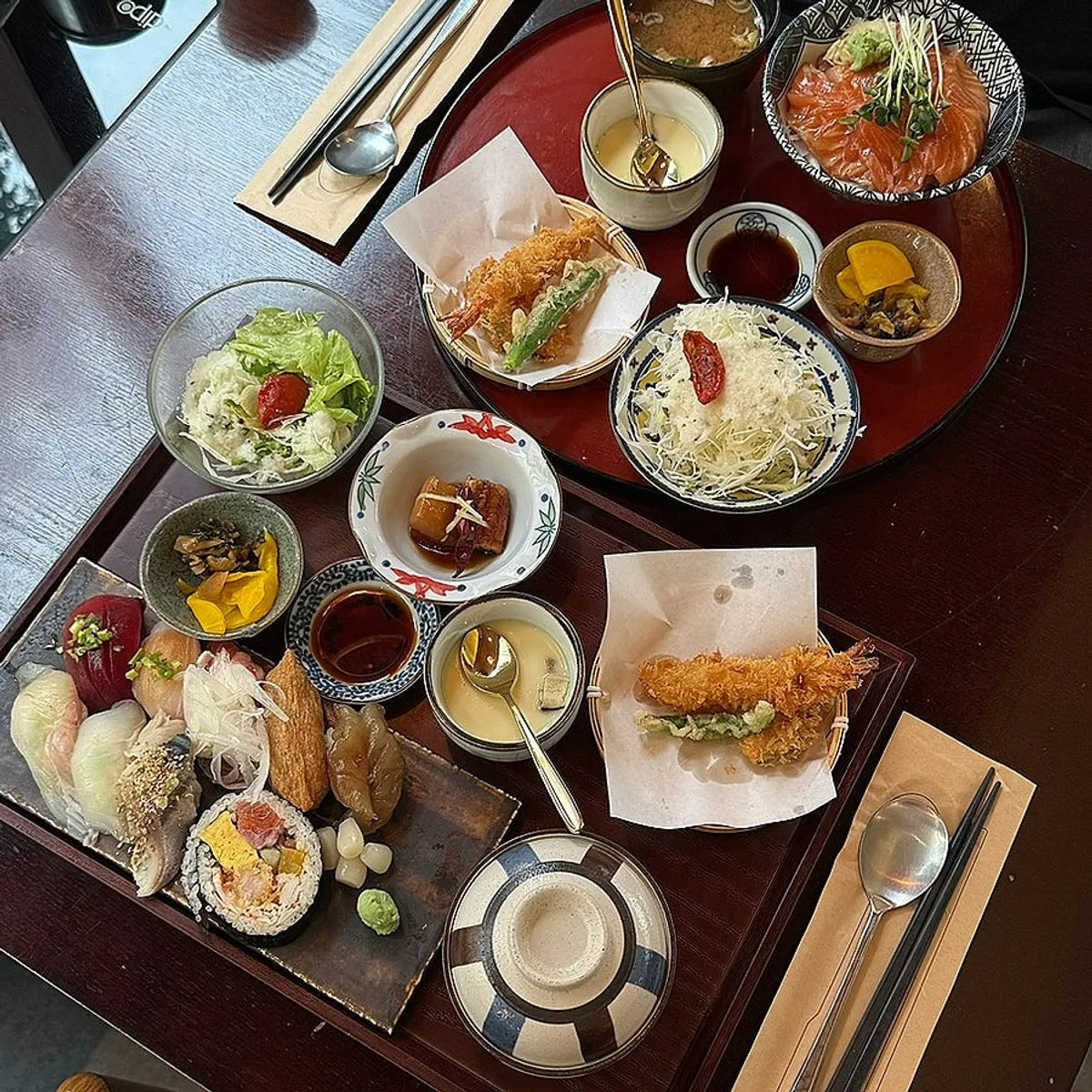Full table spread of the sushi set and sake-don set