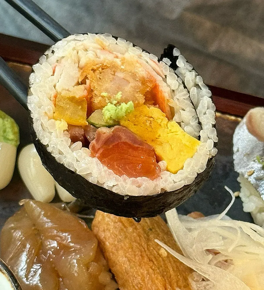 Sushi plate with tuna, salmon, and futomaki roll
