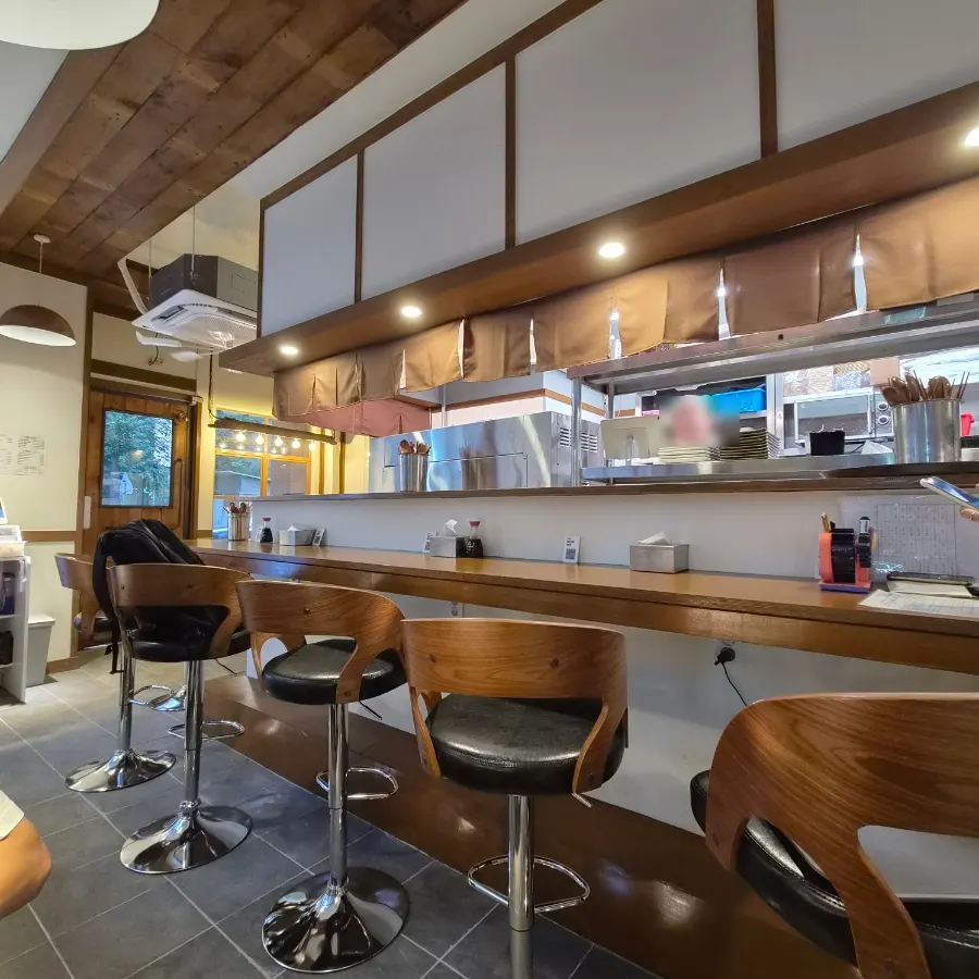 Compact interior with bar seats and 2-person tables