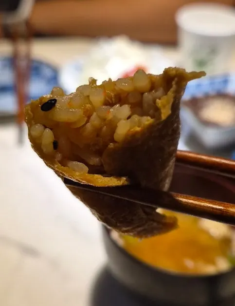 Picking up a piece of inari sushi