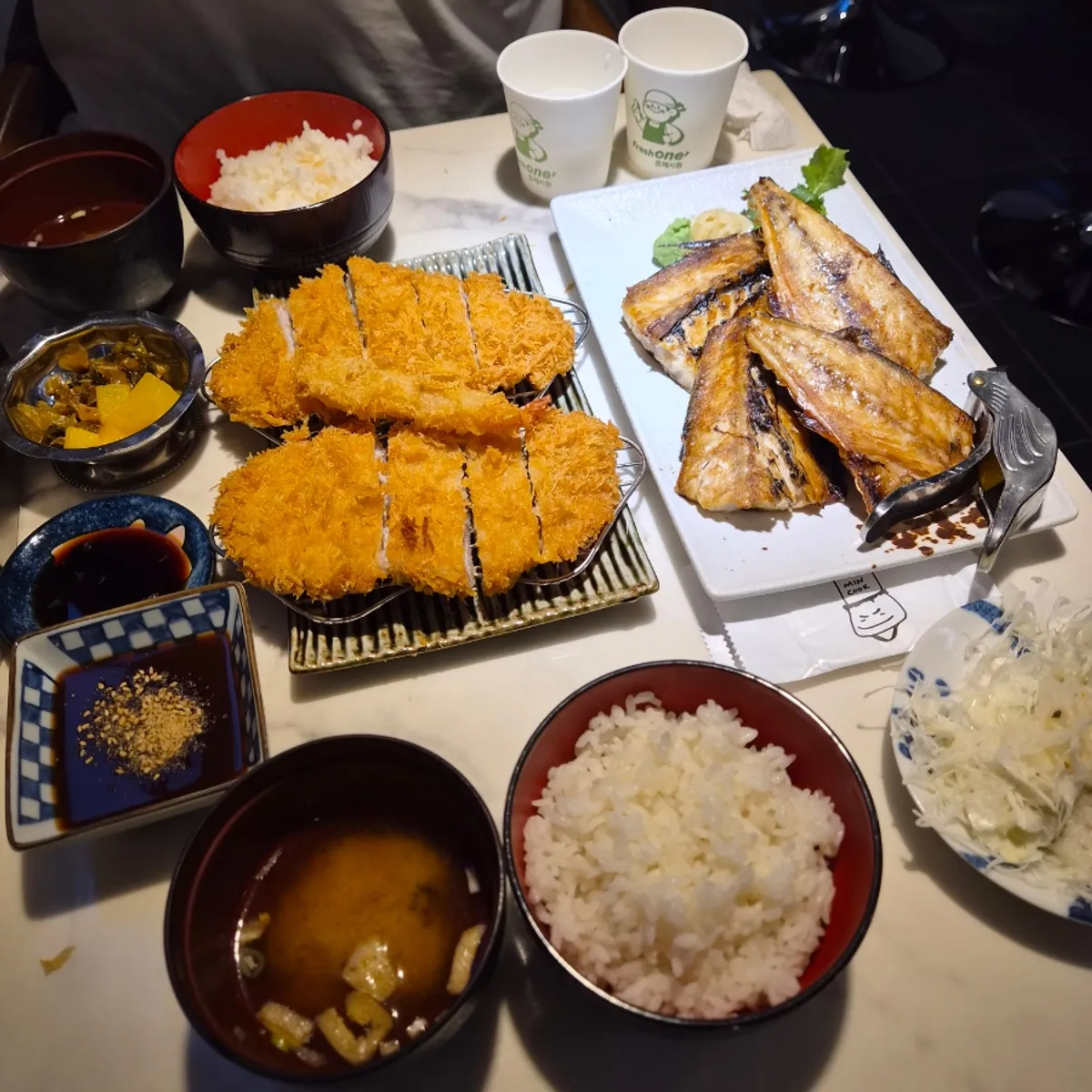 Full spread of grilled fish and katsu on the table