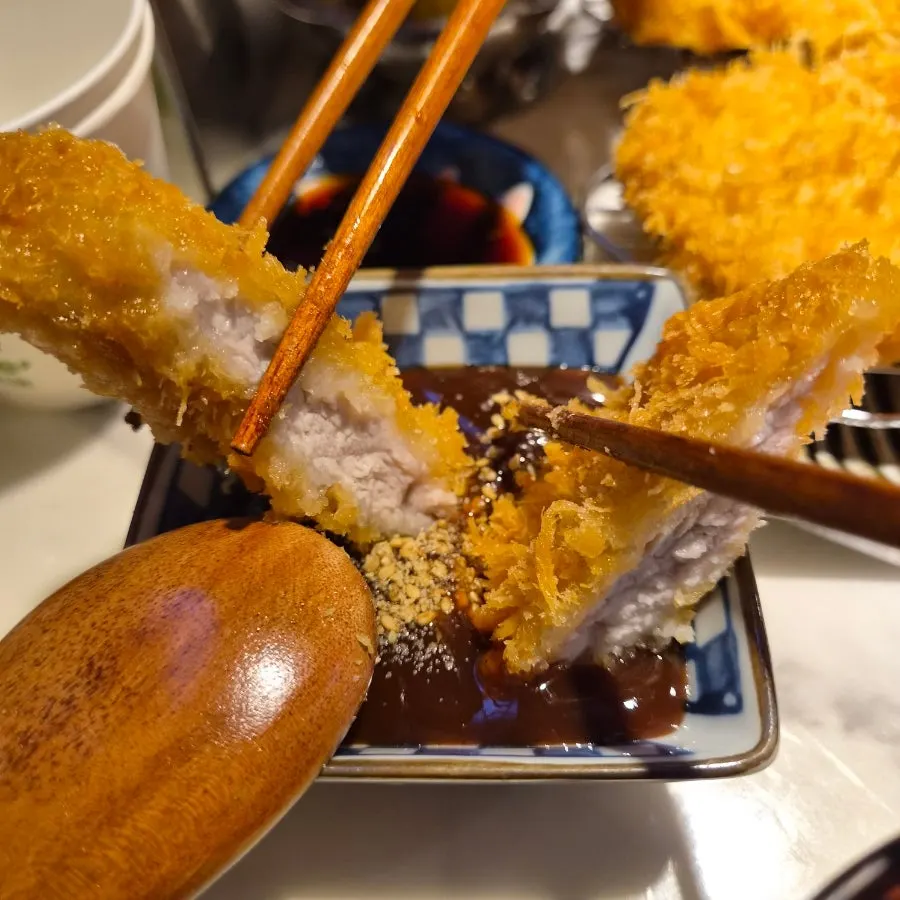 Picking up a piece of katsu