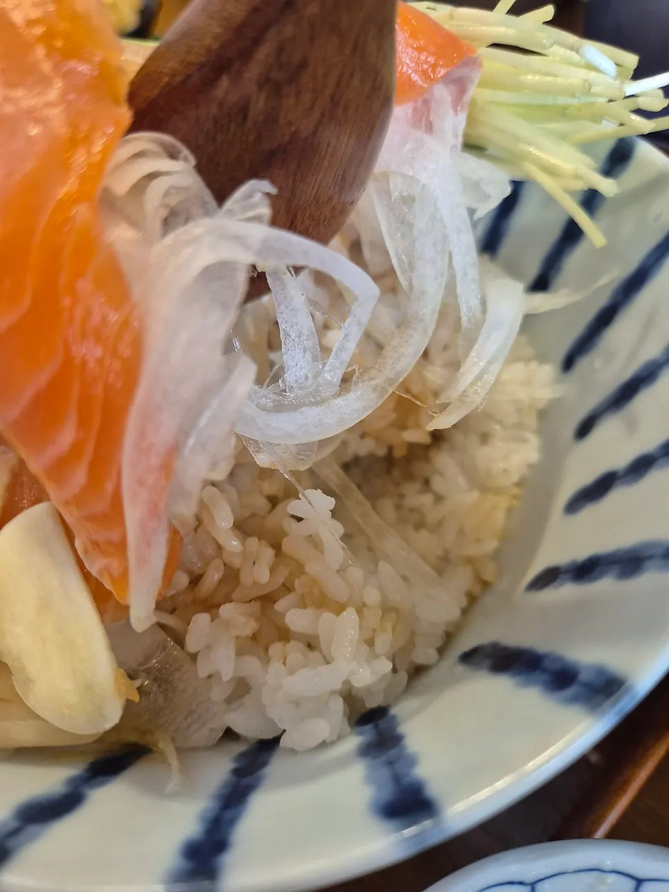 Sake-don topped with salmon, wasabi, and radish sprouts