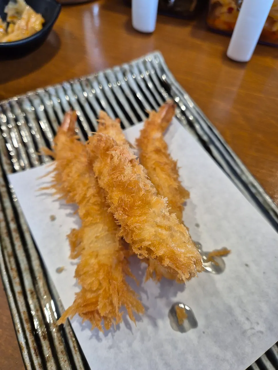 Three pieces of fried shrimp received as a service item