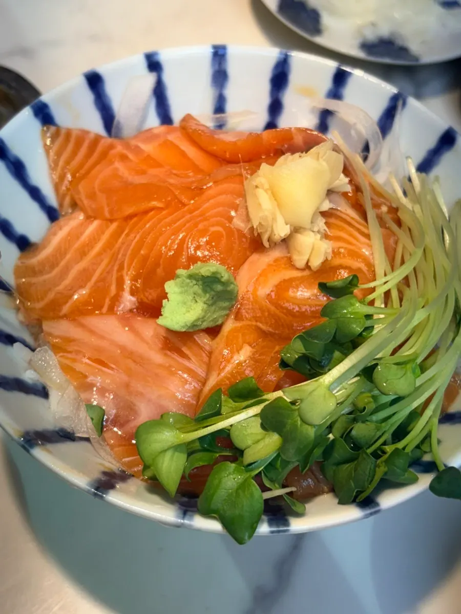 A bite of salmon on rice from the sake-don