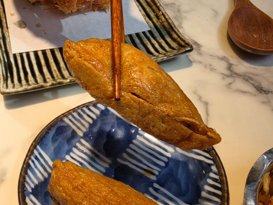 Inari sushi cut open to show the rice inside