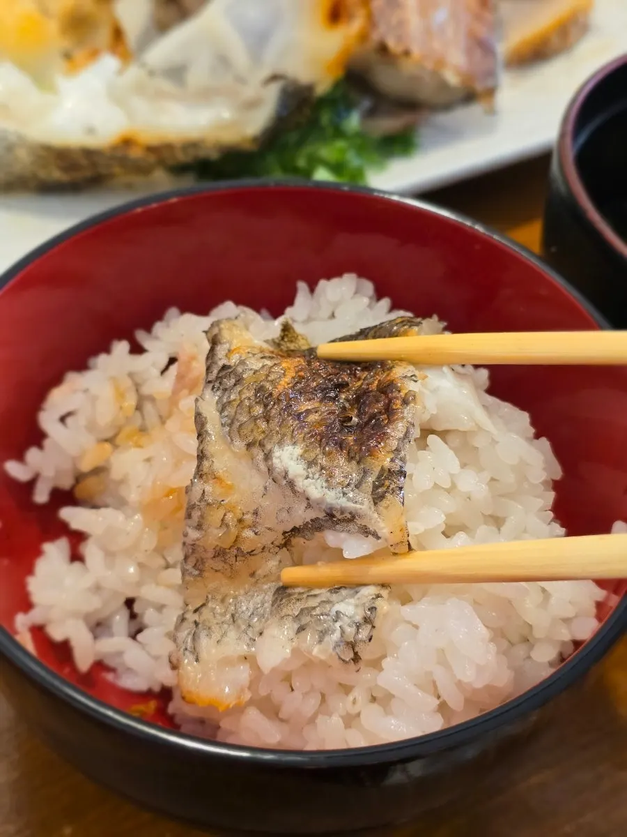 Taking a big bite of the black cod grill