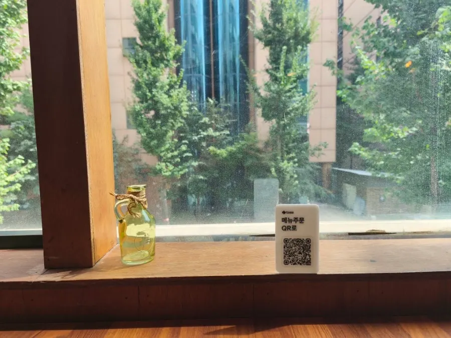 Window-side seating arrangement at Min Cook Dasima