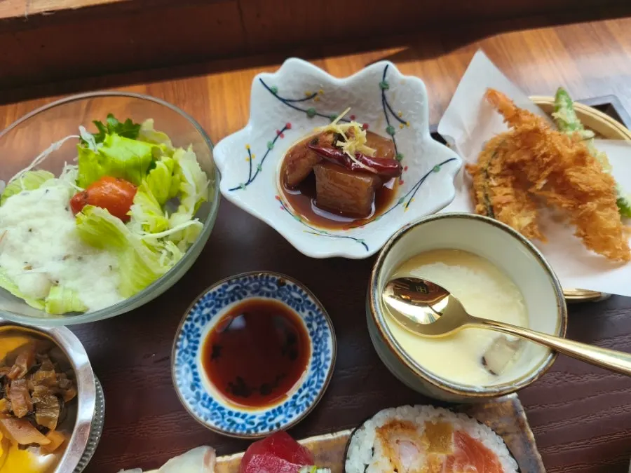 Sushi set spread with salad and side dishes