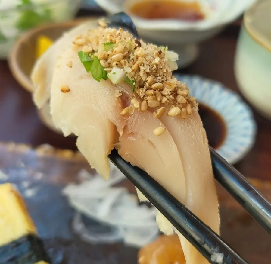 Plate of sushi topped with salmon and tuna