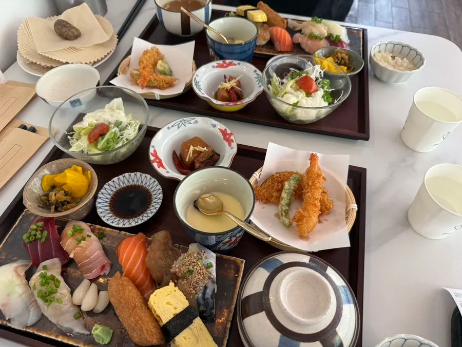Sushi set meal table with salad, miso soup, steamed egg and tempura