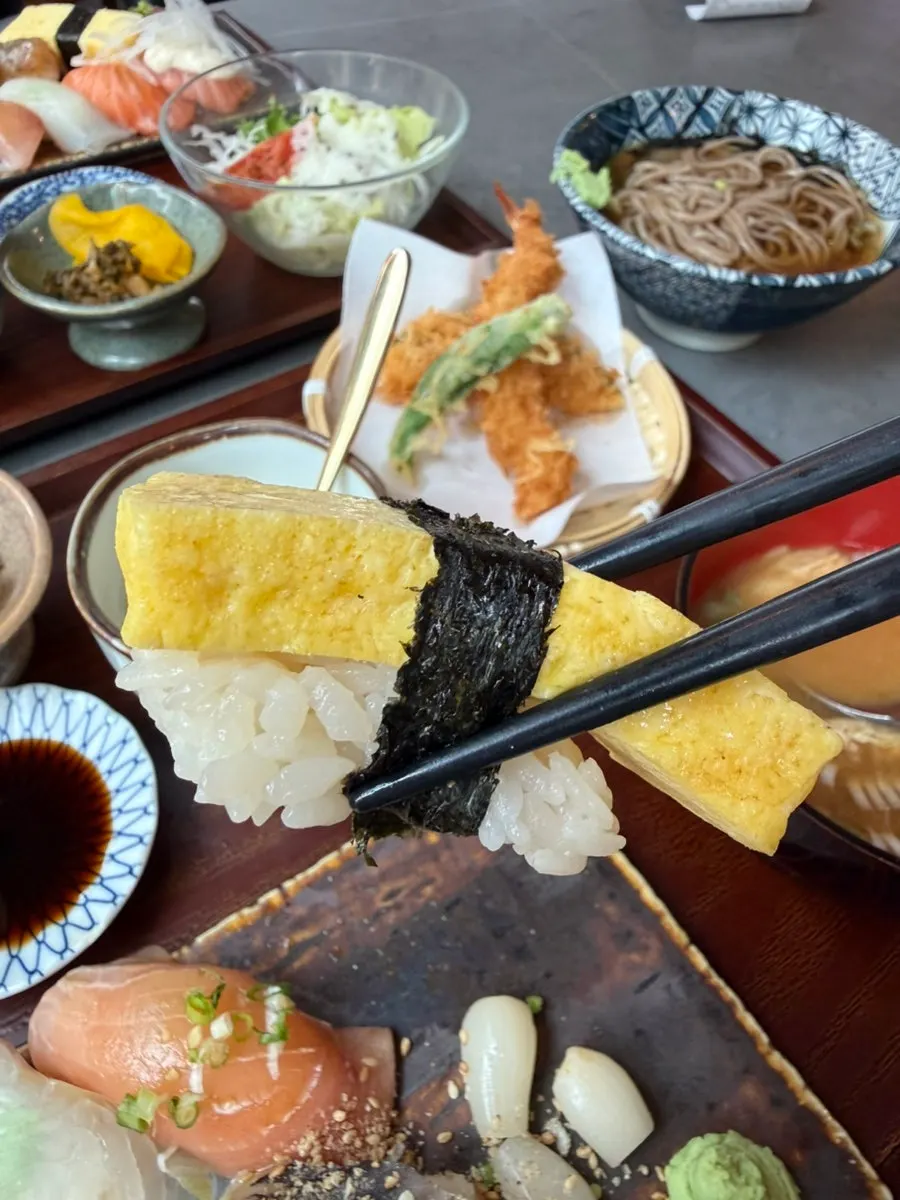 A piece of fried tofu sushi packed with rice