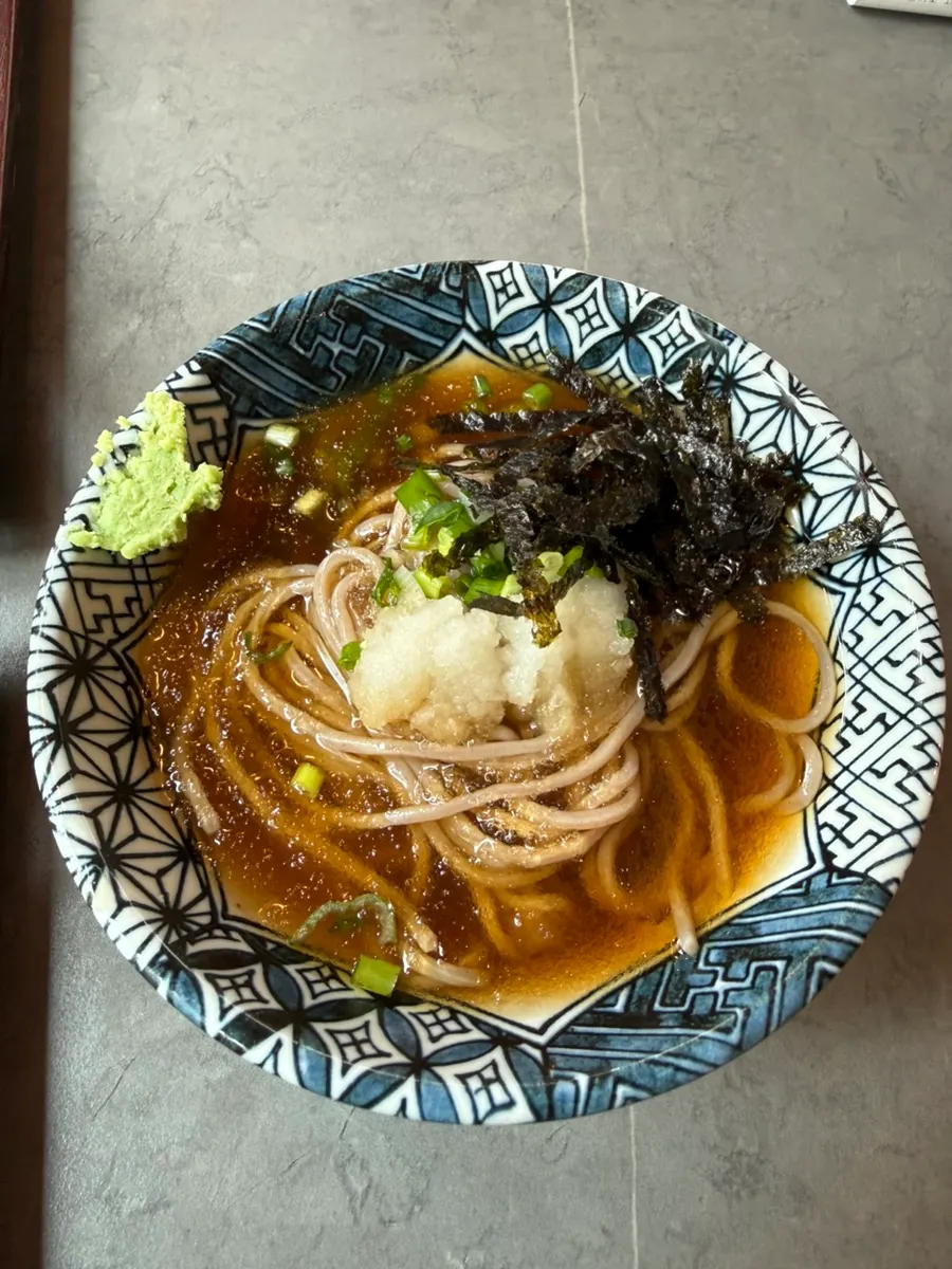 Salmon sushi topped with onion and sauce