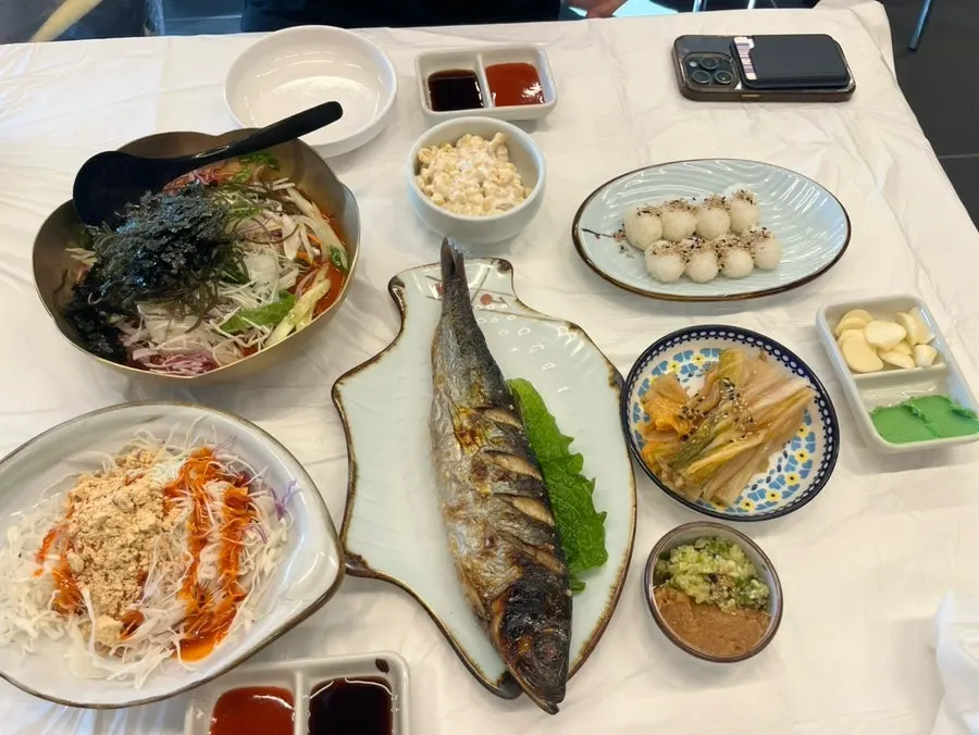 Table spread of the 2-person set with raw shrimp and live fish sashimi