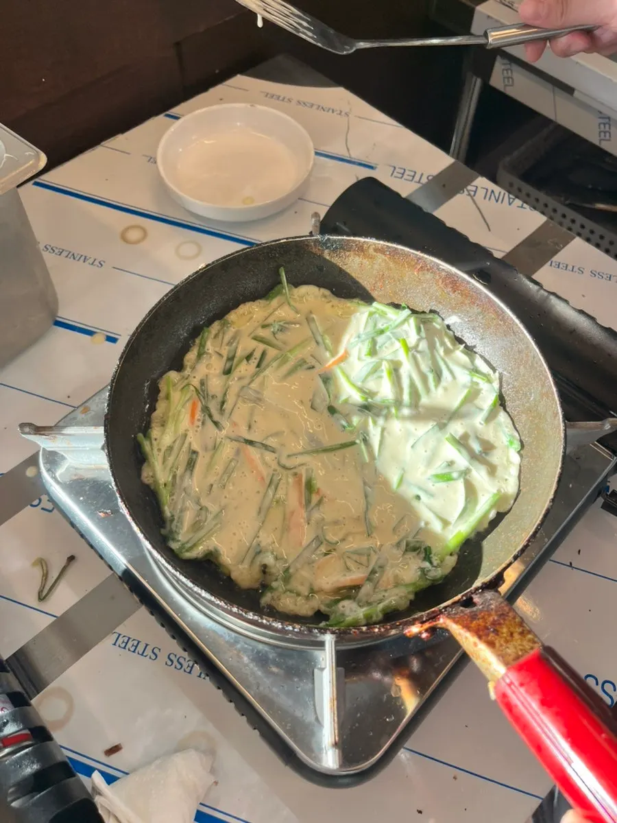 Self-grilled buchujeon cooking on the tabletop grill