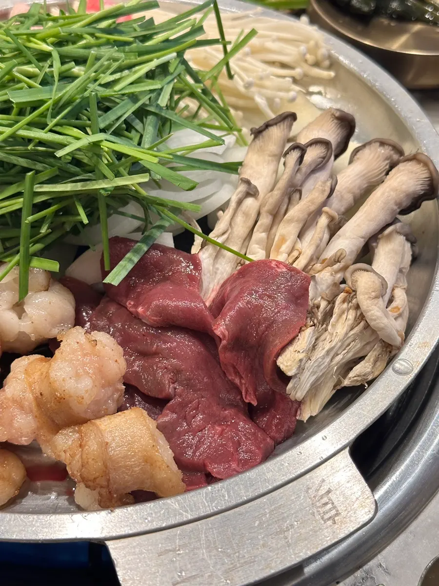 Gopchang and daechang grilling to a golden brown on the grill