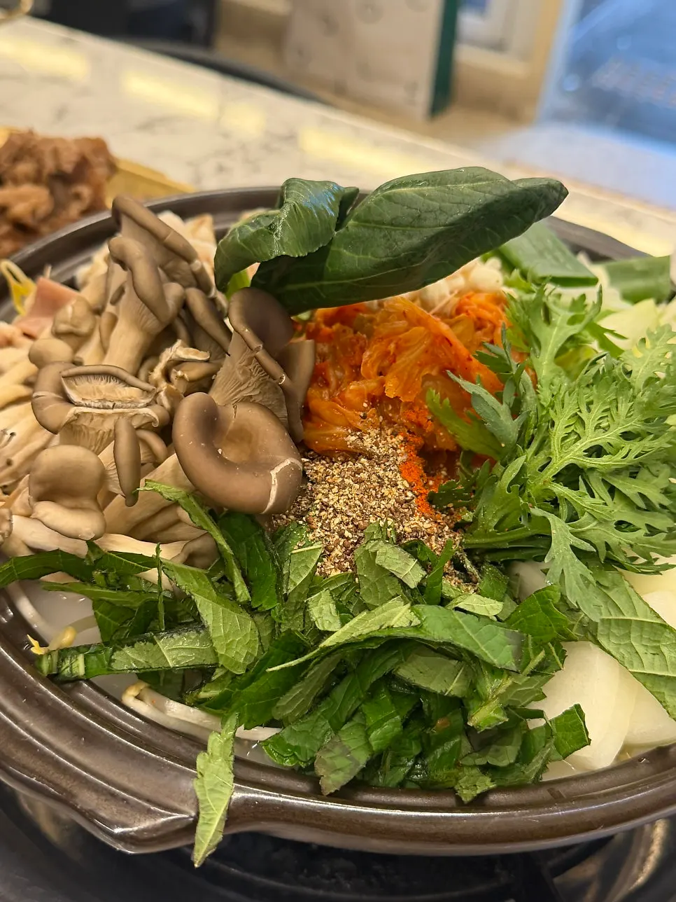 A full spread of aged kimchi beef intestine stew