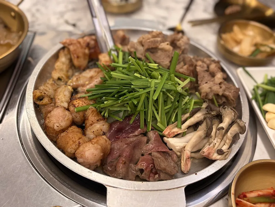 A piece of gopchang eaten with egg yolk