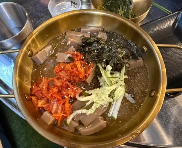 Mukguksu with bits of ice floating on top