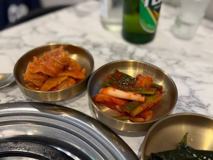 Scallion kimchi, wild garlic leaves, and pickled onion banchan