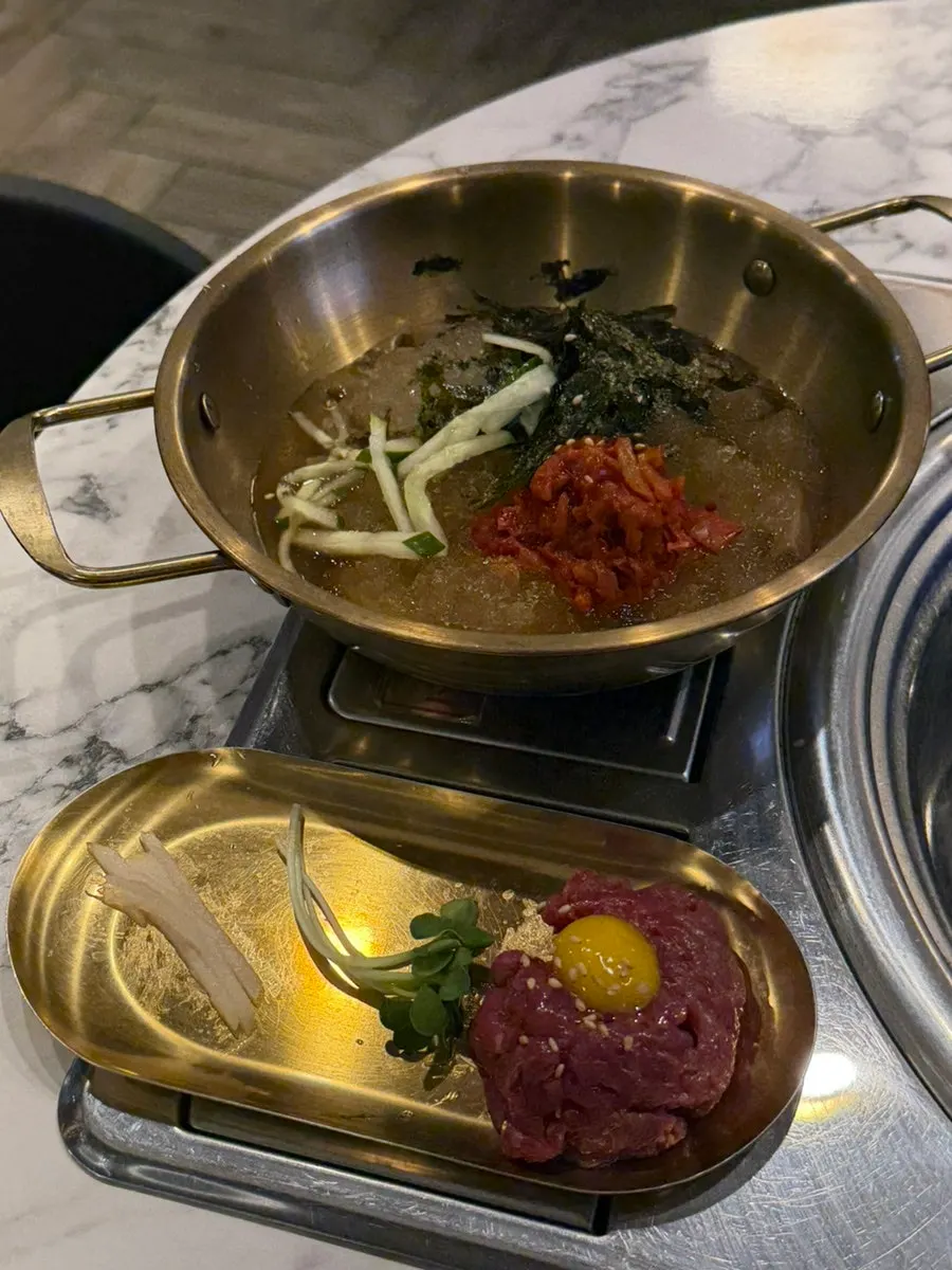Complimentary mookguksu and hanwoo yukhoe served at the table
