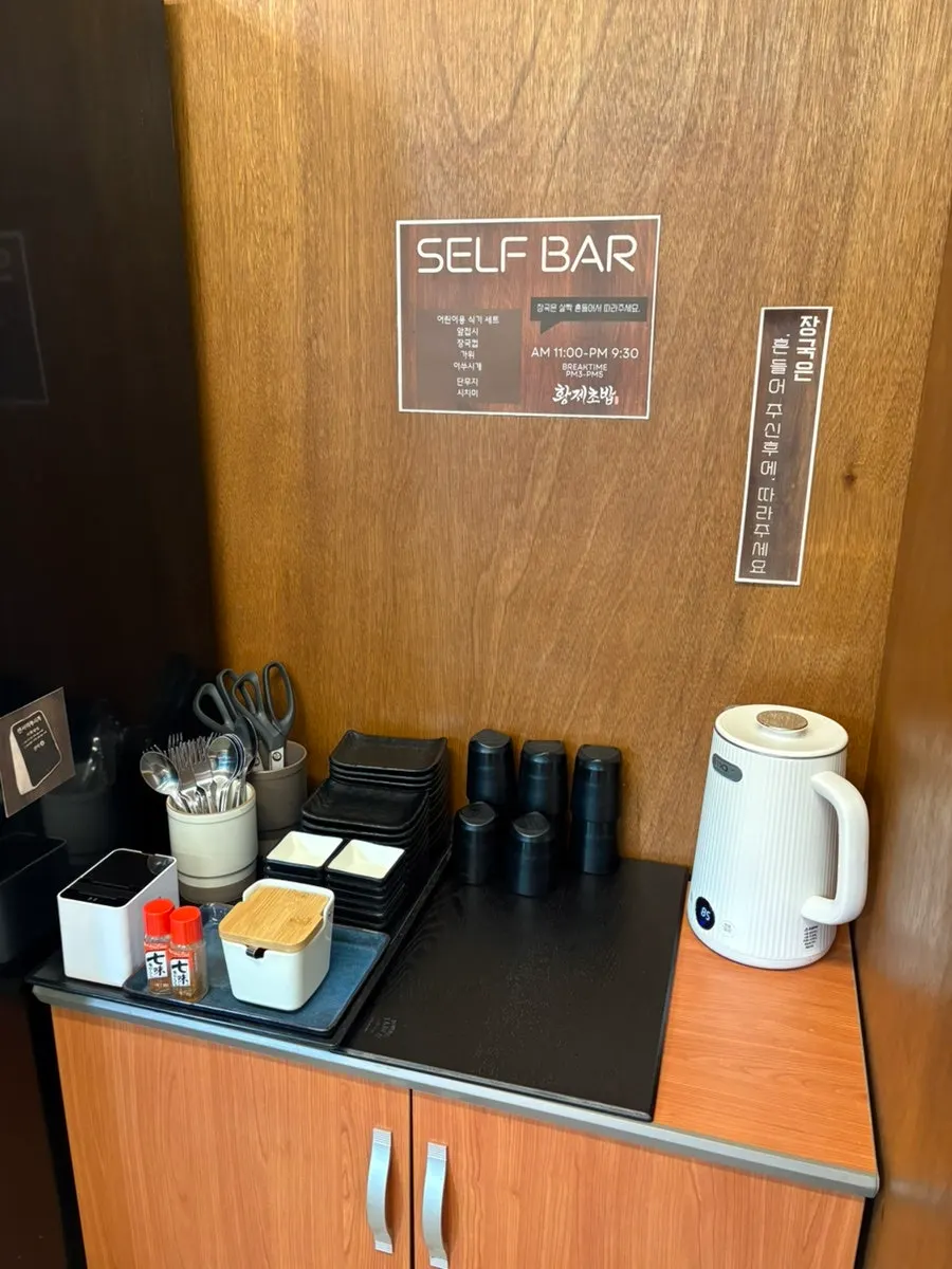 Self-service bar with kids' tableware and soup broth