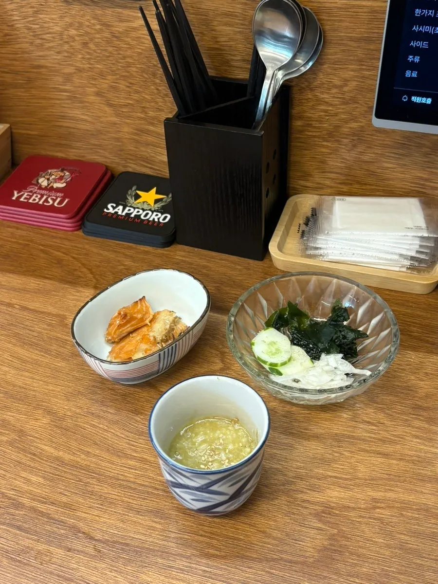 Starter dishes: abalone porridge, grilled salmon, cucumber seaweed salad