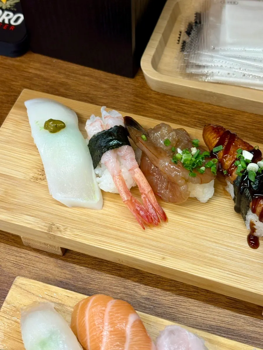 Sushi topped with squid, sweet shrimp, and soy sauce shrimp