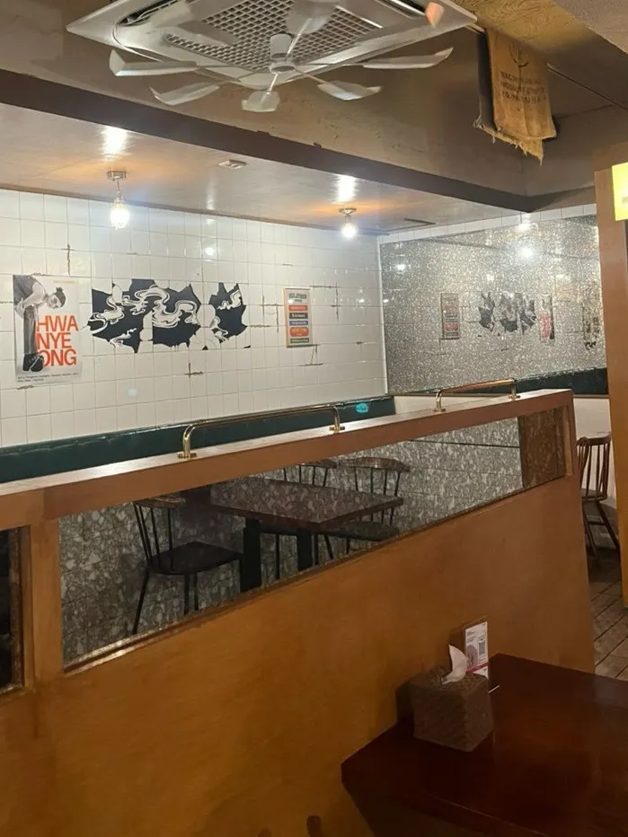 Seating area with tiled walls and wooden tables