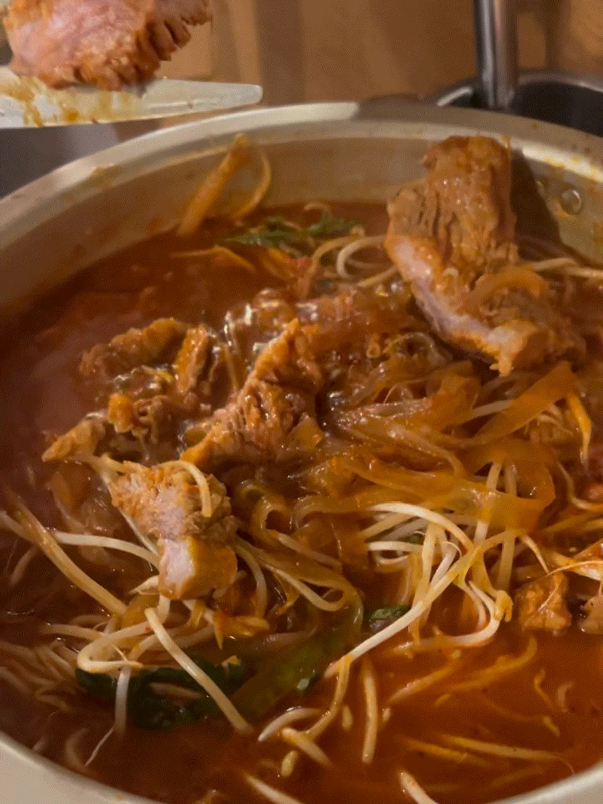 Pot of galbi-jjim piled with bean sprouts and glass noodles