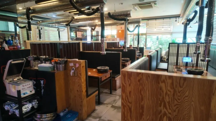 Dining hall arranged mostly with 4-person tables