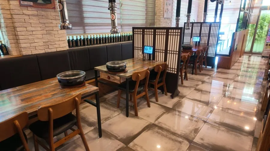 View of the restaurant with ventilation fixtures over every table
