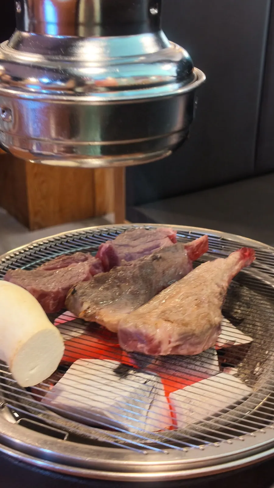 Lamb grilling over a charcoal grate