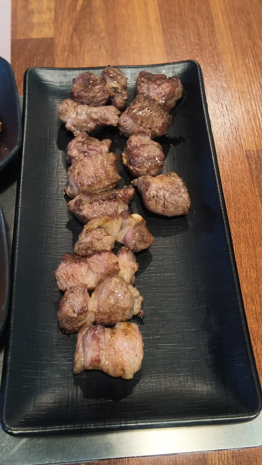 Close-up of grilled shoulder rack still on the bone
