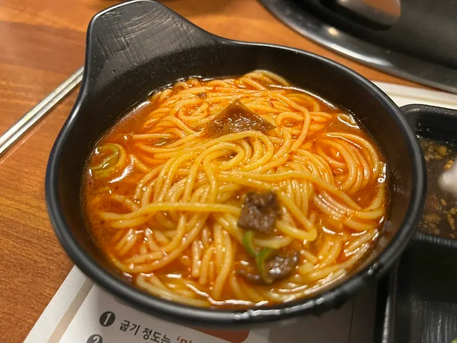 A bowl of tangy-spicy onmyeon with corn noodles