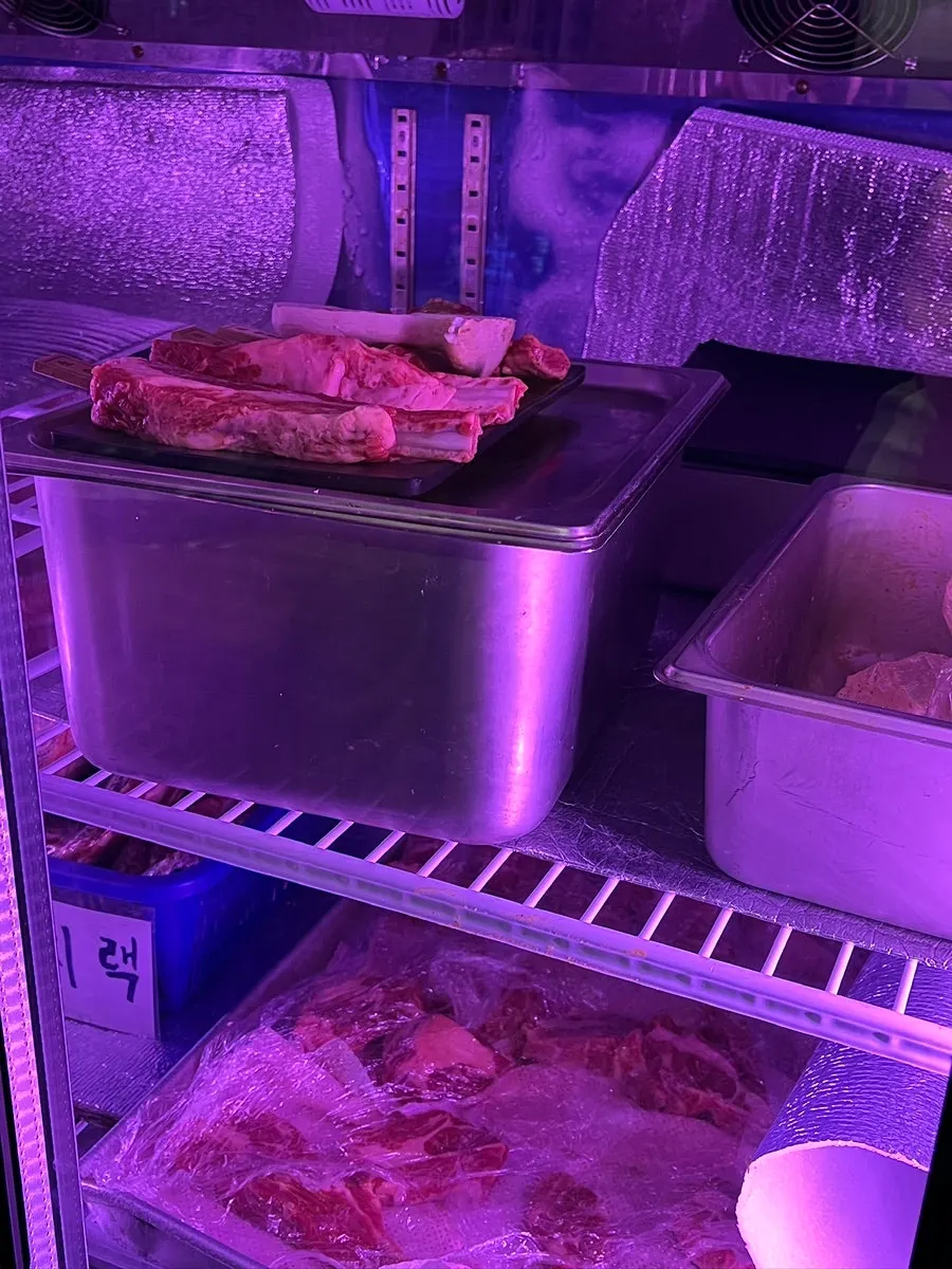 Aging fridge in the restaurant holding lamb sorted by cut