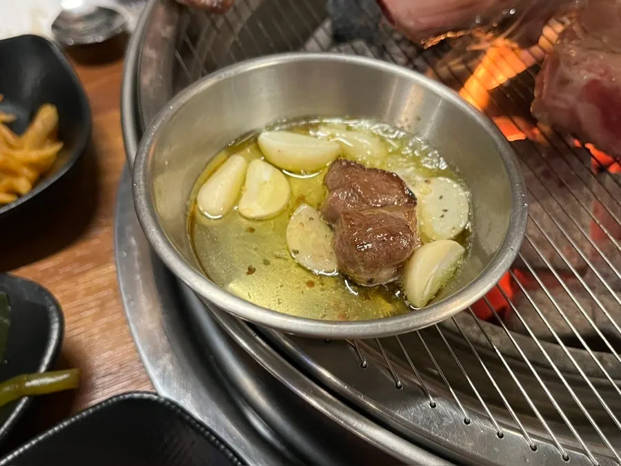 A piece of lamb served with salt and wasabi