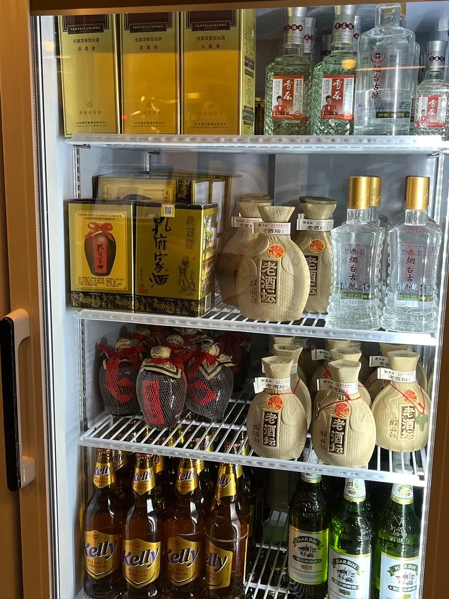 Drink fridge stocked with gaoliang liquor and bottled beers
