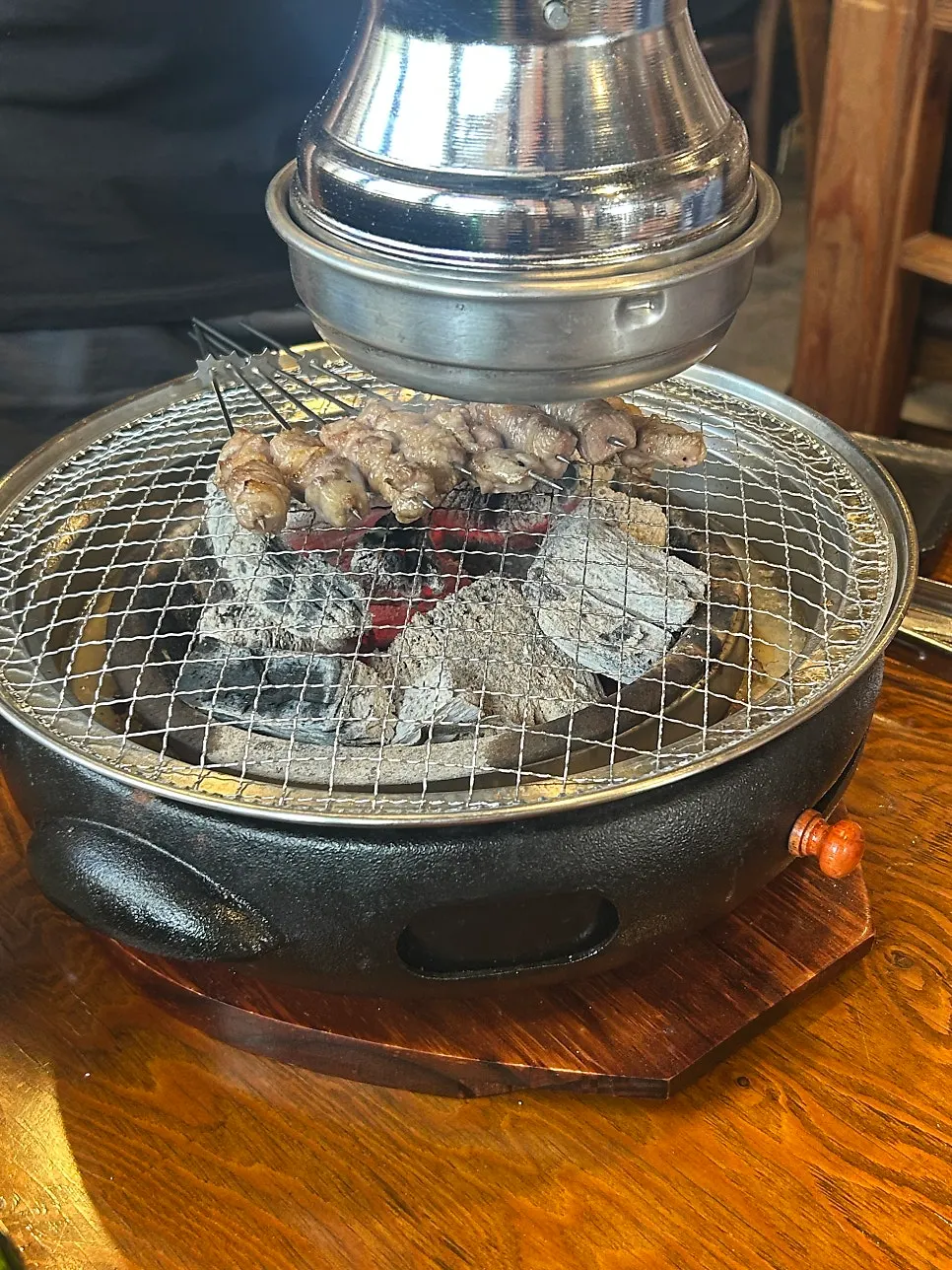 Thick lamb ribs grilling on the tabletop grill