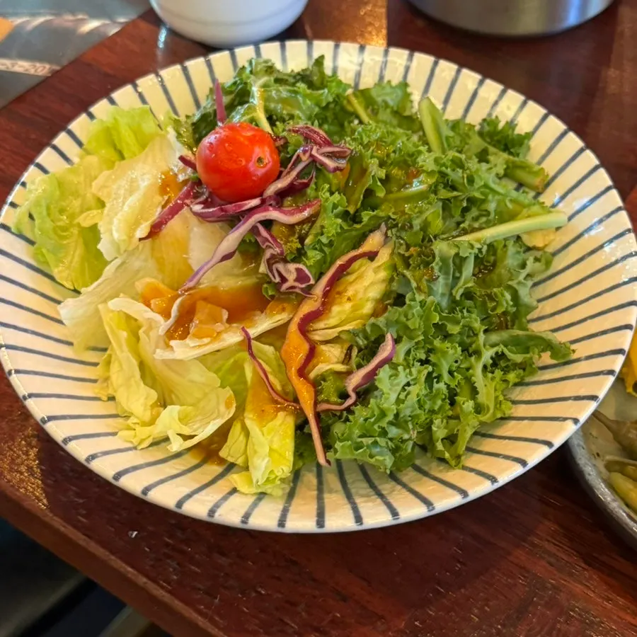 The first plate of the course, a salad with soy sauce dressing