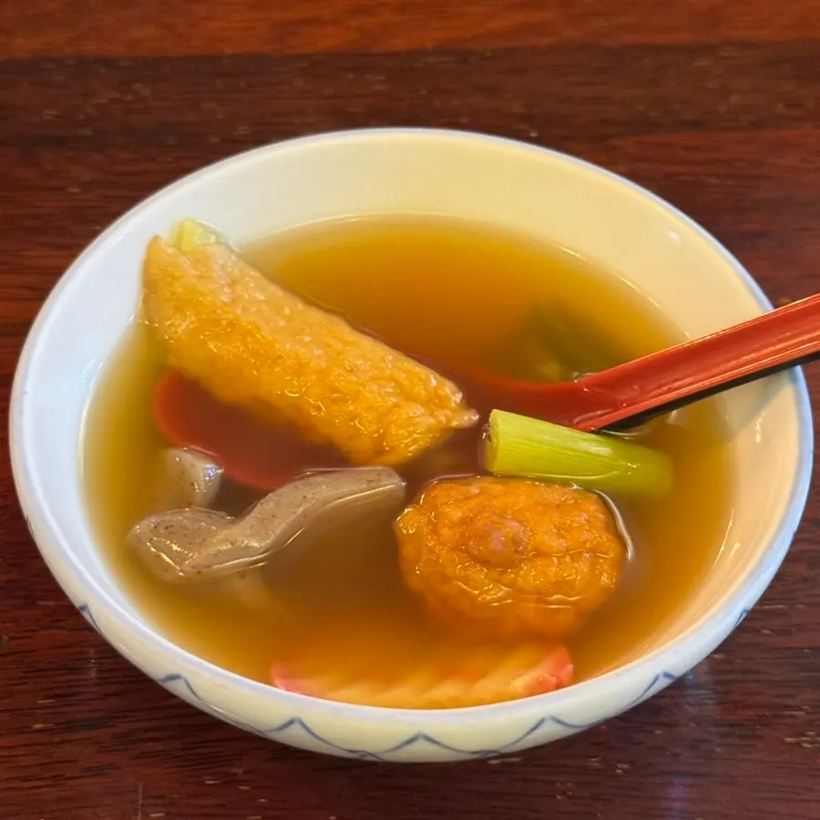 An individual serving of fish cake soup