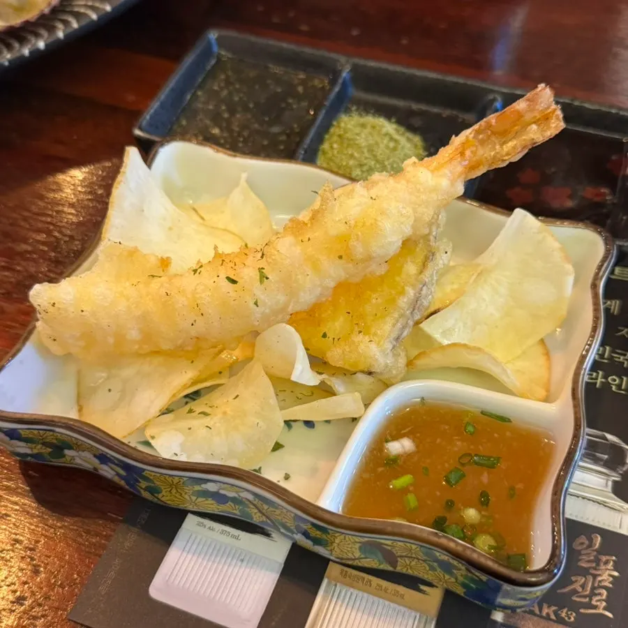 Plate of fried shrimp, sweet potato fritters, and cassava chips