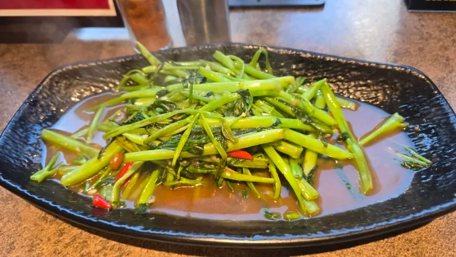 Morning glory stir-fry served on a long plate