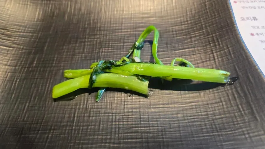 Water spinach stir-fry picked up with chopsticks