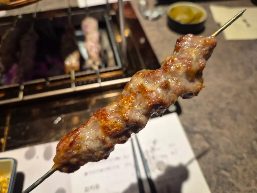 Freshly grilled lamb skewer with a glass of beer