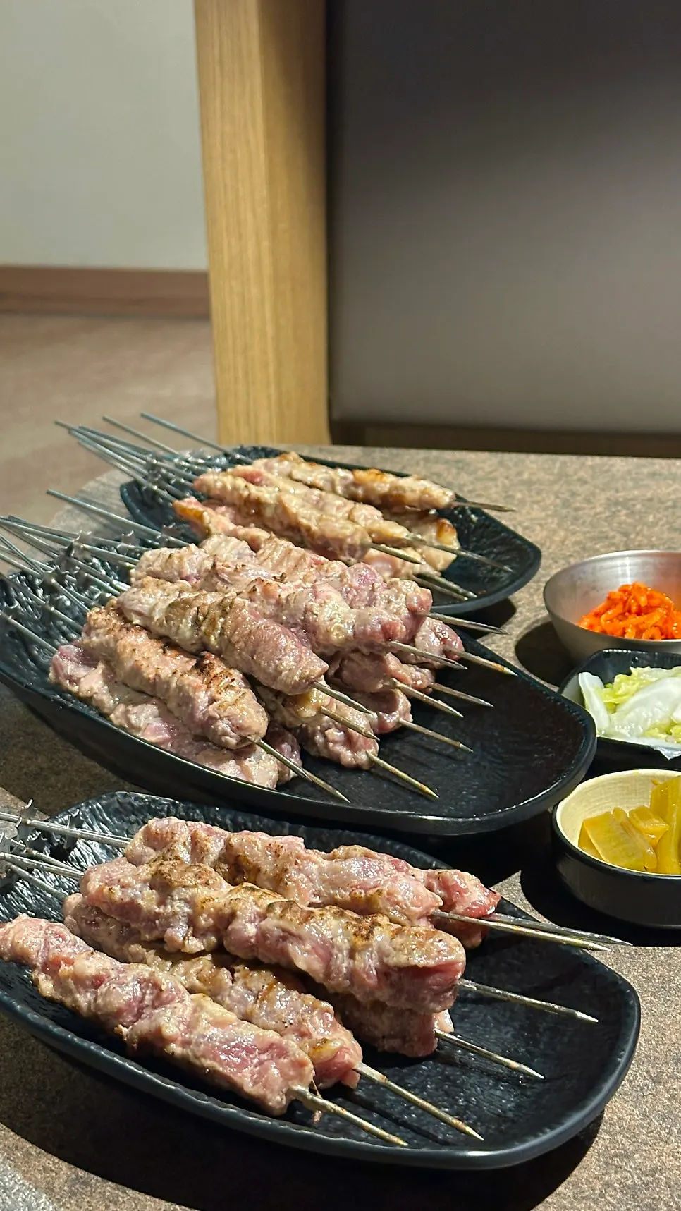 Vertical shot of thick lamb skewers on the charcoal grill